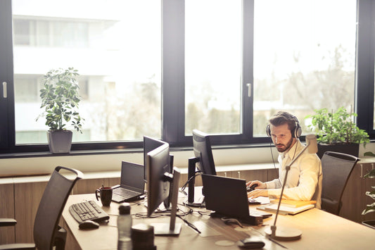 Bright office space with ergonomic office furniture and large windows and plants