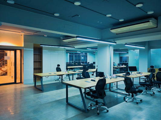 Numerous black eco-friendly chairs and tables in an office