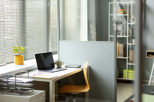Example of a modern office furniture set with a laptop in a bright room
