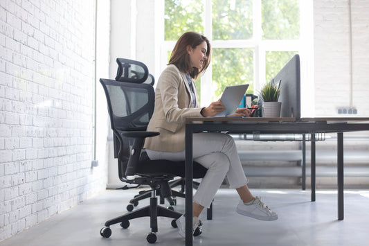 Side view of business woman working comfortably in an ergonomic office chair