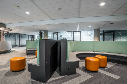 Modern office space with curved bench seating areas for collaboration 